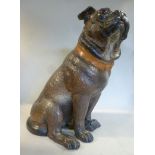 An early 20thC painted pottery model, a seated Pug with glass eyes 12.