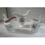 Three New Hall porcelain cream jugs, similarly decorated with flora, viz. one of helmet design (No.