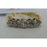 An 18ct gold graduated claw set diamond ring 11