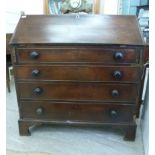 A George III mahogany bureau, the fall flap enclosing a fitted interior,