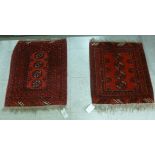 Two similar Bokhara mats each with four guls on a red ground 24'' x 21'';