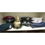 British and German replica military head gear: to include a Pickelhaube;