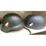 Two replica German WWII tin helmets with decals OS1