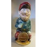 A late 19thC majolica figure 'The Drunken Army Reservist' seated on a barrel,