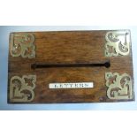 An Edwardian light oak desktop letter box with rivetted and applied,