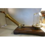 An early 20thC brass vacuum pump with an attendant glass chamber,