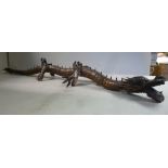 A late 19th/early 20thC Japanese carved wooden articulated model dragon 23''L