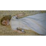 A Simon & Halbig bisque head doll with painted features and weighted, sleepy eyes,