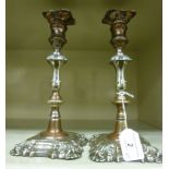 A pair of late 19thC Georgian style silver plated candlesticks, each with a vase shaped socket,