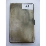 A silver folding cigarette case with engine turned decoration,