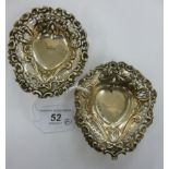 A pair of late Victorian embossed silver heart shaped sweet dishes with decoratively pierced