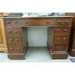An early 20thC mahogany desk, the top with an inset fabric scriber,
