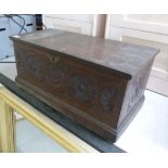 An 18thC style stained and rosette carved boarded oak box with a hinged lid 11''h 24''w