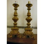 A pair of late 19th/early 20thC Italianate carved giltwood candlestands with floral and foliate