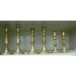 Three similar pairs of 19thC brass ejector candlesticks with knopped stems, on canted,