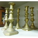 Three similar pairs of 19thC brass ejector candlesticks with knopped stems, on canted,