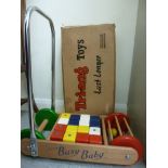 A Triang Busy Baby push-along truck with painted bricks and a rolling ball game to the front,