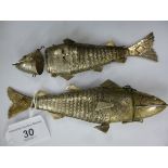 Two almost identical, white metal, flexible fish ornaments with hinged heads,