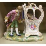 A 20thC Continental porcelain group, a man wearing a frockcoat and breeches,