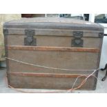 An early 20thC canvas coloured pine trunk with a domed,