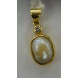 A gold coloured metal pearl and diamond set pendant 11