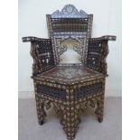 A late 19thC Moroccan mother-of-pearl inlaid hardwood chair with spindled panels,