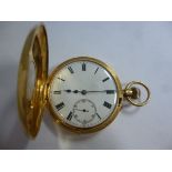An 18ct gold cased half hunter pocket watch with engraved black enamelled Roman numerals around the