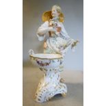 An early/mid 19thC KPM porcelain figure, a standing flower seller,