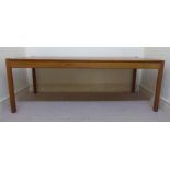 A 1960s teak coffee table with a reversable top, raised on turned legs 18''h 51.