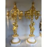 A pair of Victorian style decoratively cast gilt metal candelabra,