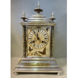 An early 20thC electroplated steel cased mantel clock, the pagoda top with five finials,