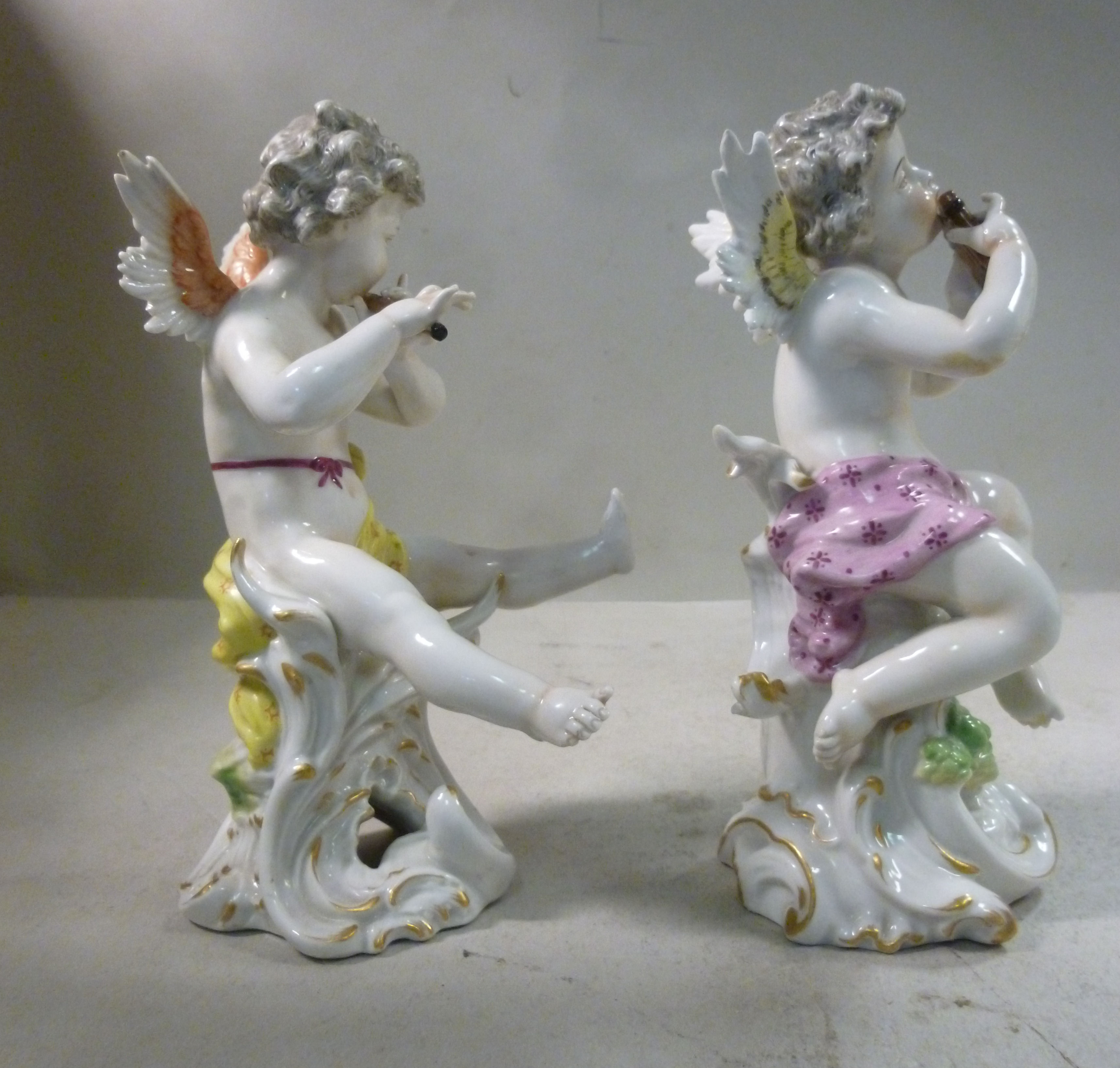 A pair of early 20thC Frankental porcelain seated cherubic figures, one playing panpipes, - Image 4 of 7