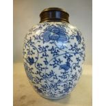 An 18thC Chinese Kangxi period porcelain ovoid shaped jar with a turned, carved hardwood cover,