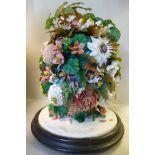 A late Victorian fabric and shellworked floral centrepiece display, in a woven cane basket,