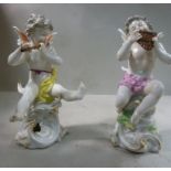 A pair of early 20thC Frankental porcelain seated cherubic figures, one playing panpipes,