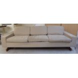 A 1960s three person box settee with a low, level upstand back,