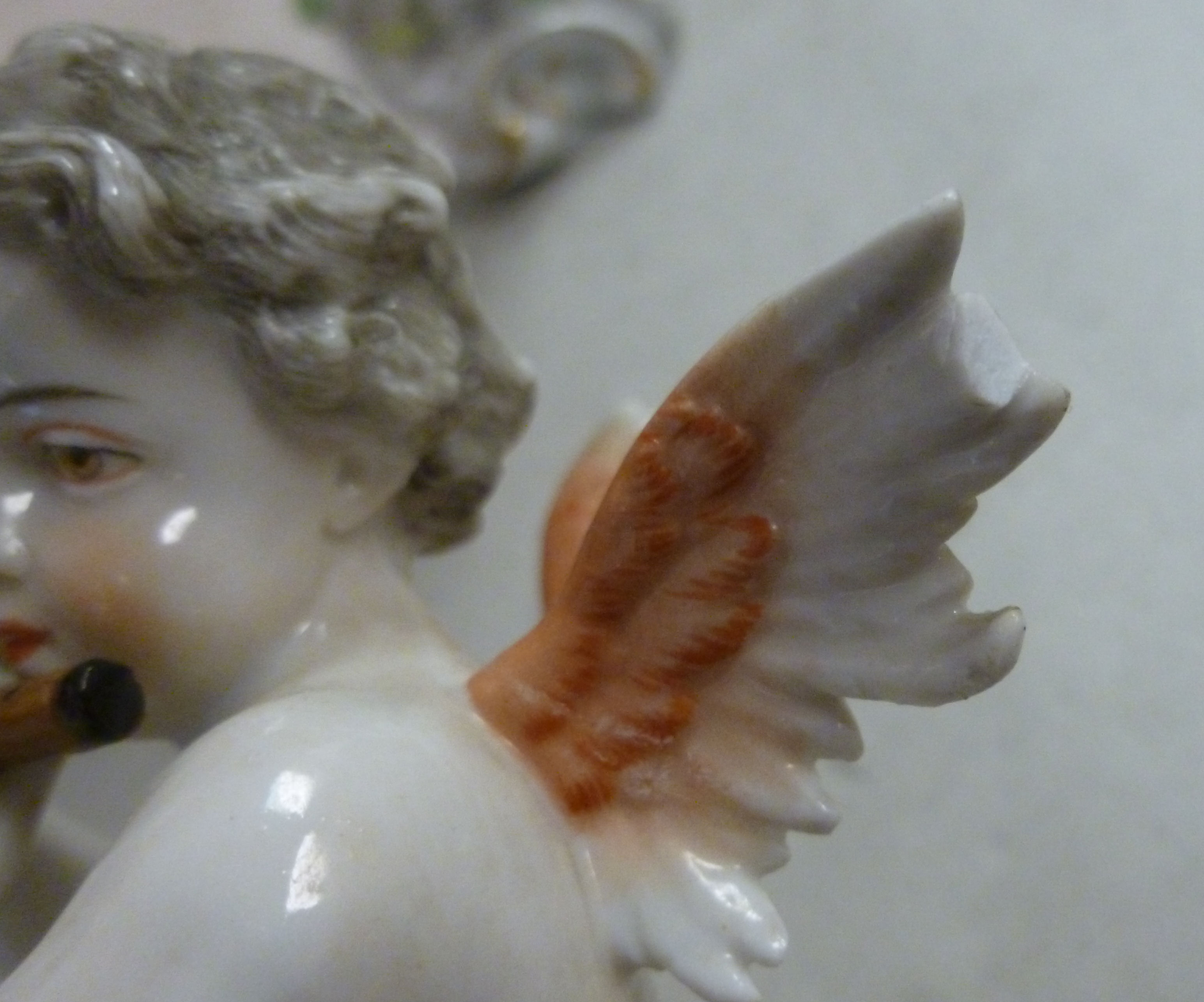 A pair of early 20thC Frankental porcelain seated cherubic figures, one playing panpipes, - Image 6 of 7