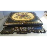 A late Victorian black lacquered, moulded papier mache writing box, embellished with painted,