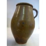 A 17thC glazed earthenware ewer of barrel form (possibly Nottingham) with a plain strap handle 8.