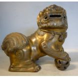 An 18th/19thC Chinese gilt bronze model, a lion dog,