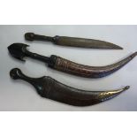 Three early 20thC Persian daggers, each having a carved horn handle the blades 7.