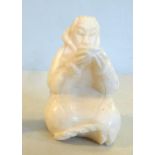 An Inuit carved marine ivory seated figure, holding a bowl bears indistinctly inscribed marks 2.