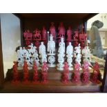 A late 19thC Cantonese intricately carved beetlenut stained and naturally coloured ivory chess set,