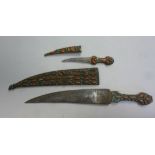 Four late 19thC Persian daggers: to include an example with a gilded handle,