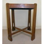 An early 20thC Arts & Crafts light oak side table, the top having canted corners, a wide,