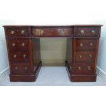 A late Victorian mahogany inverted breakfront desk, the top set with a green hide scriber,