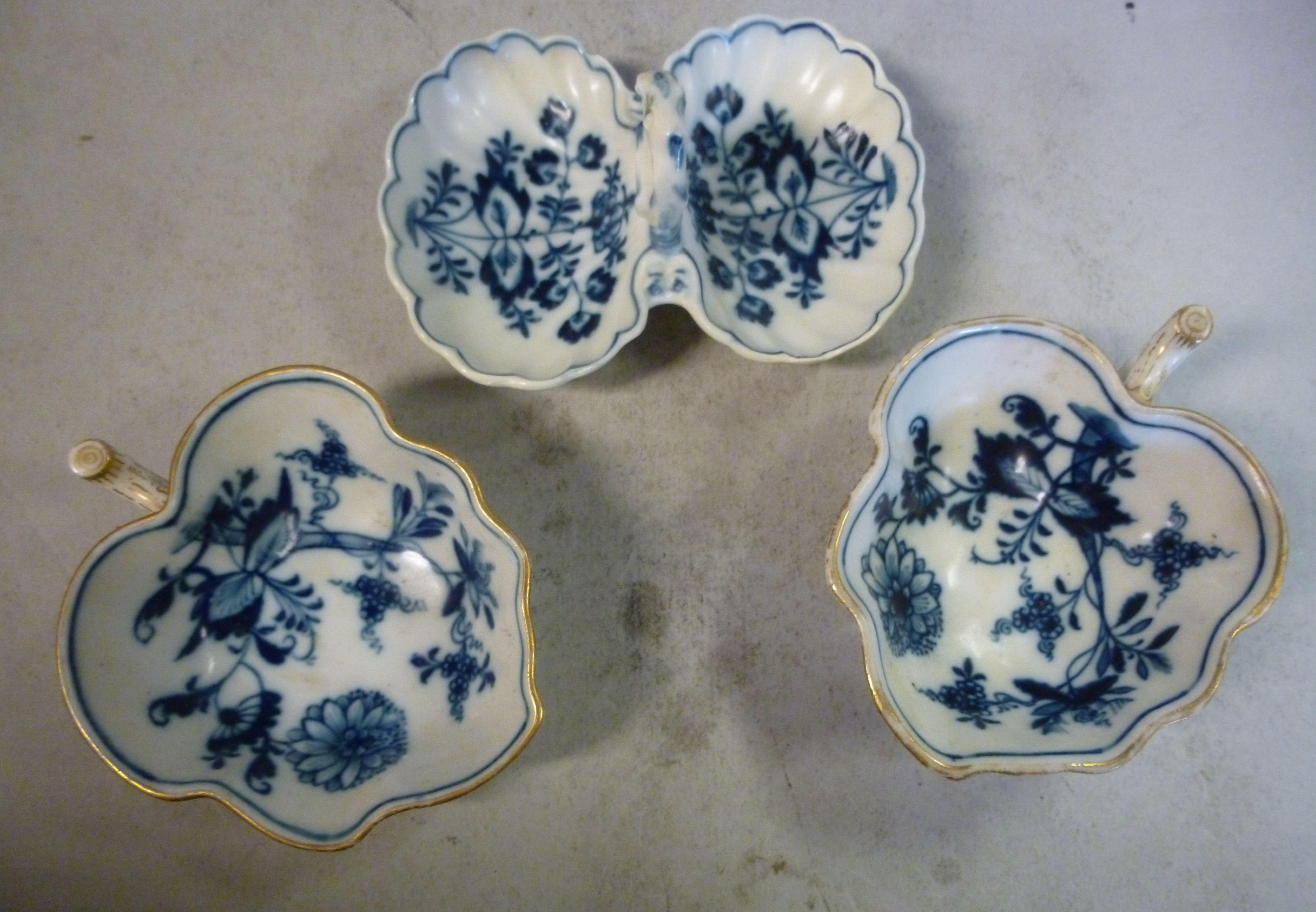 A pair of late 19thC Meissen porcelain pickle dishes with naturalistically moulded twig handles,