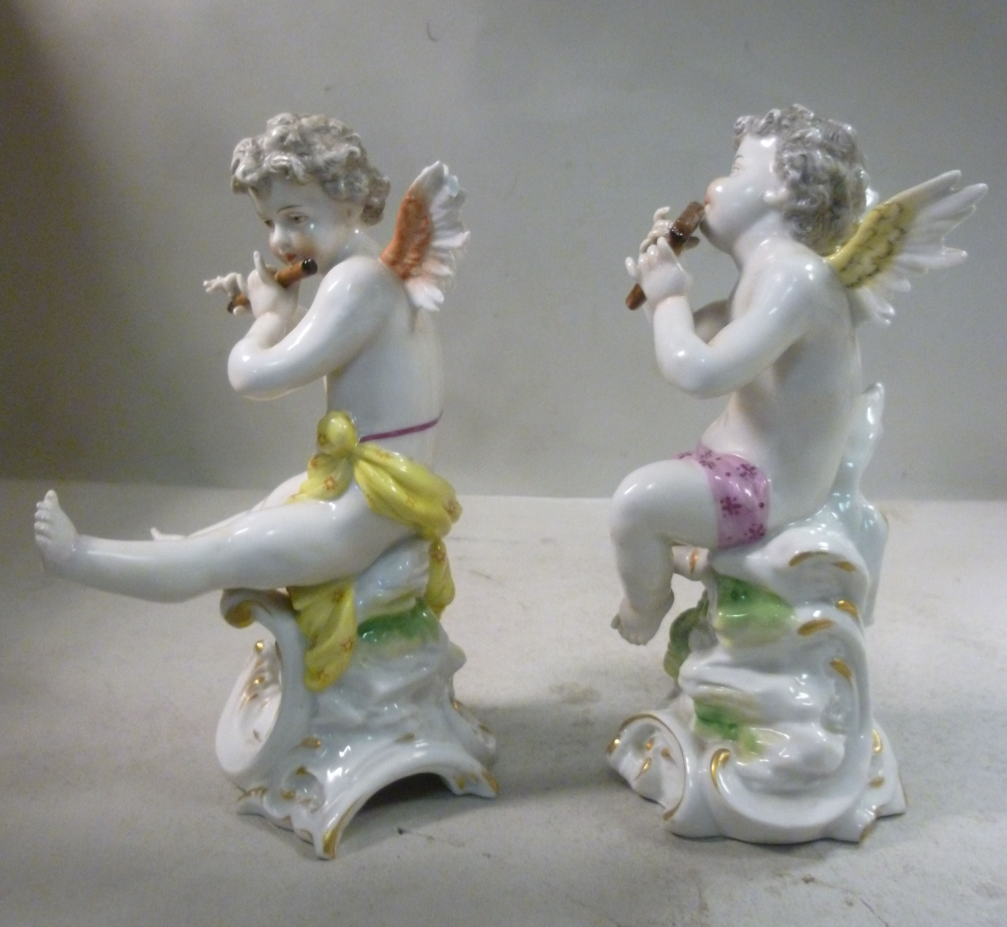 A pair of early 20thC Frankental porcelain seated cherubic figures, one playing panpipes, - Image 2 of 7