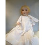 An early 20thC Armand Marseille bisque head doll with painted features and weighted sleeping eyes,