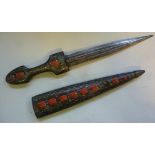 An early 20thC Persian dagger, having a white metal inlaid hardwood handle and matching scabbard,